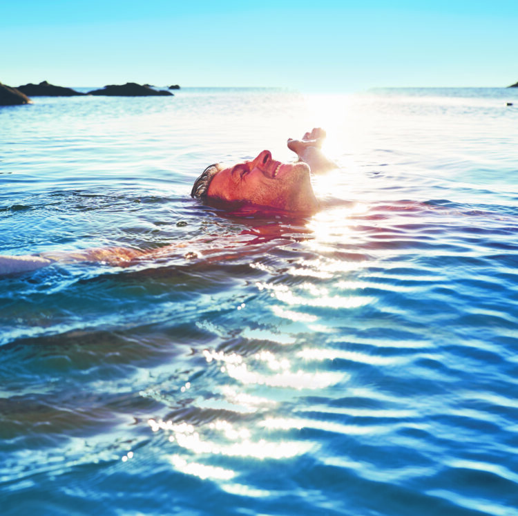 man floating in water